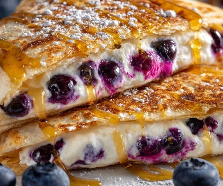 Delicious blueberry breakfast quesadilla on a plate with fresh berries