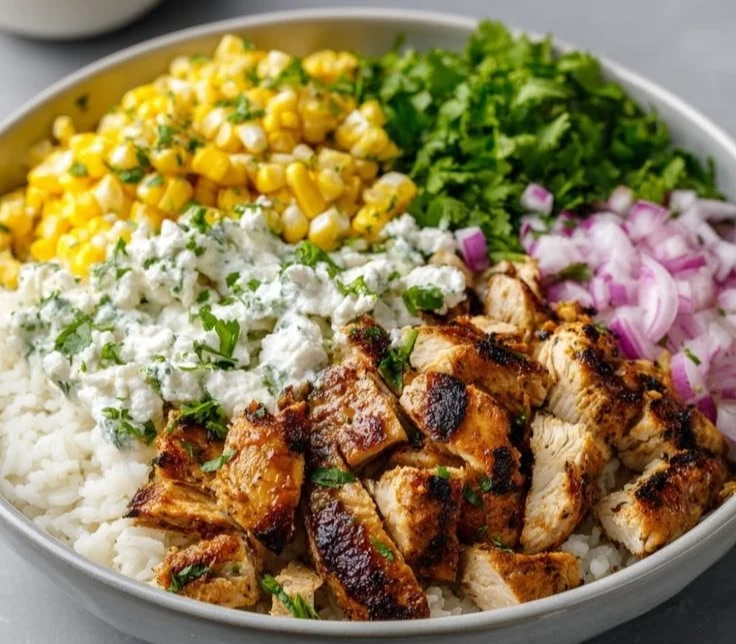Grilled chicken bowl with cilantro lime rice and Mexican street corn salad