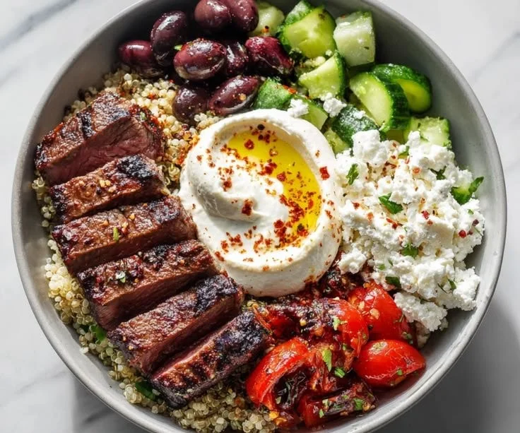 Mediterranean steak bowl with skillet steak, colorful veggies, and lemon-herb quinoa.