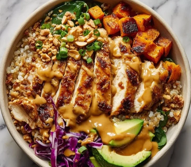 Delicious Peanut Chicken Protein Bowl topped with fresh vegetables and peanuts