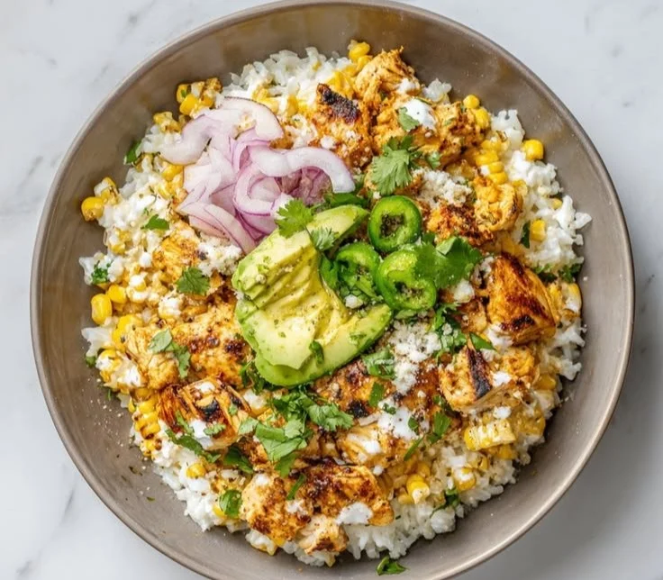 Delicious Mexican street corn chicken bowls topped with fresh cilantro and lime.