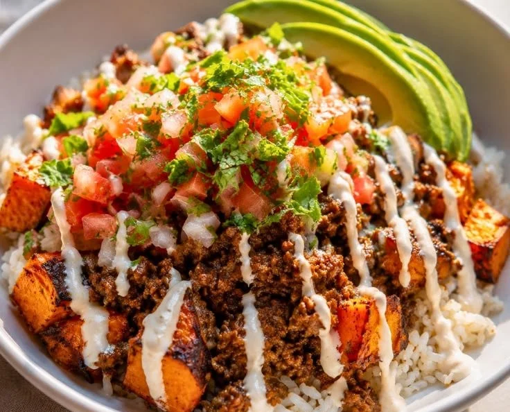 Delicious sweet potato taco bowl with savory ground beef and toppings.