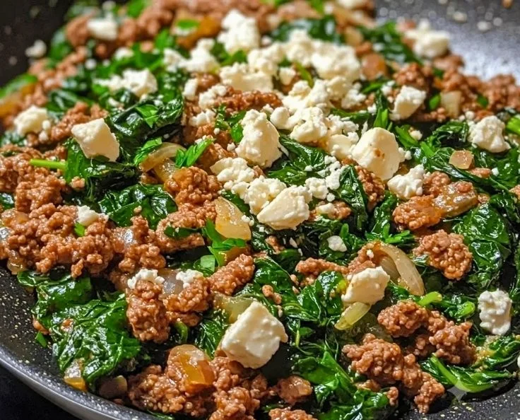 Ground beef skillet with spinach and feta cheese in a pan