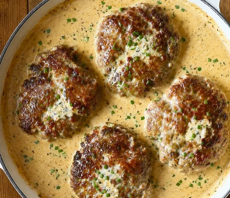 Salisbury steaks served in a rich horseradish parmesan sauce